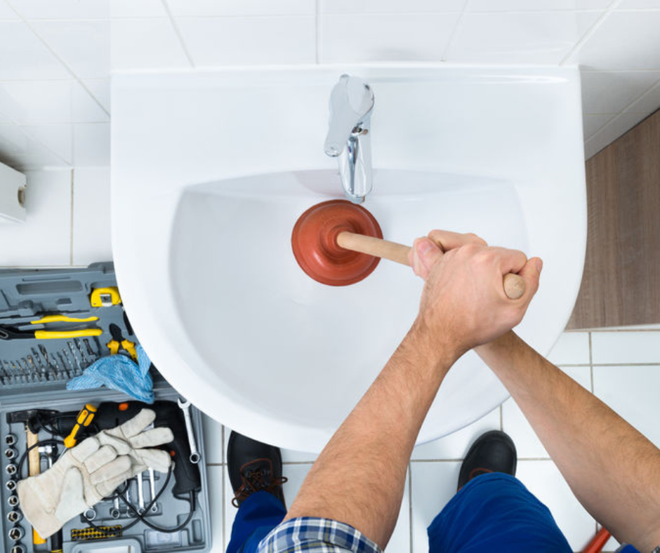 garland plumber unclogging drain with plunger